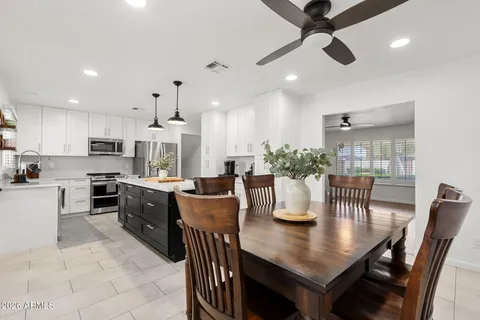 an open kitchen with dining table and chairs