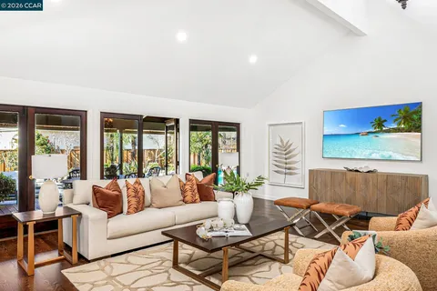 a kitchen with stainless steel appliances granite countertop a sink a stove and a refrigerator