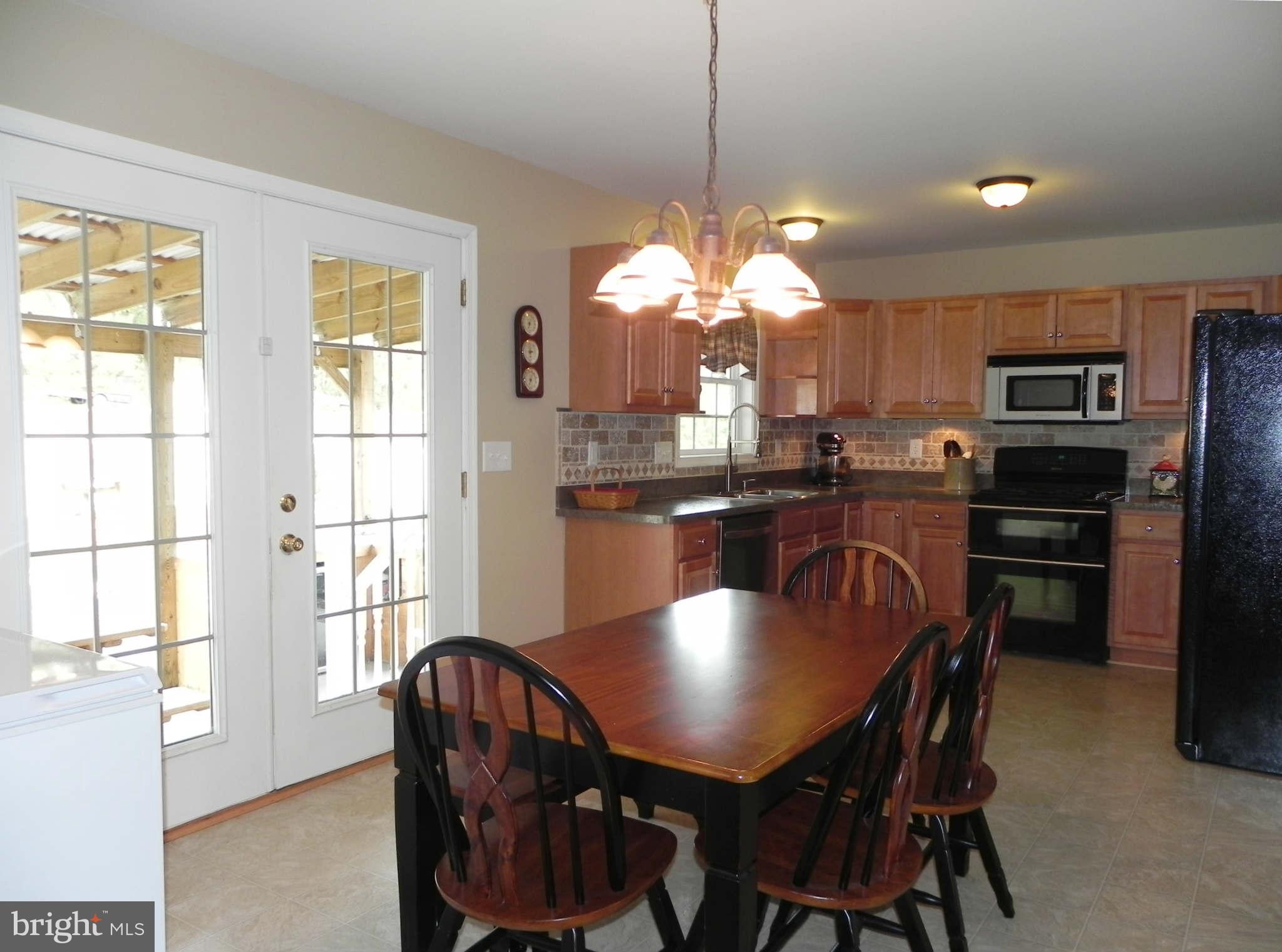 293 Fantasia Road Inwood, WV 25428 - Photo 10 of 30 Kitchen leads to Covered Patio