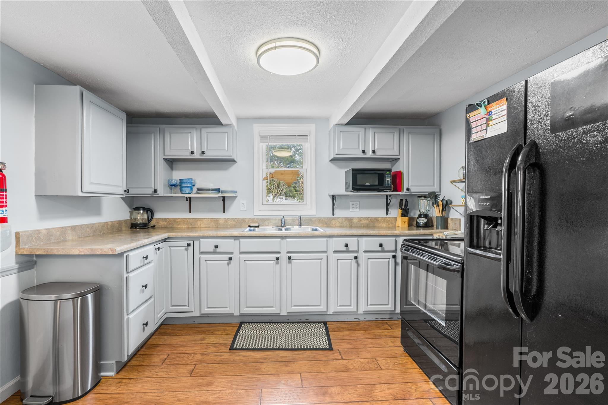 23 Maxwell Road Asheville, NC 28805 - Photo 11 of 47 a kitchen with granite countertop a sink stainless steel appliances and cabinets