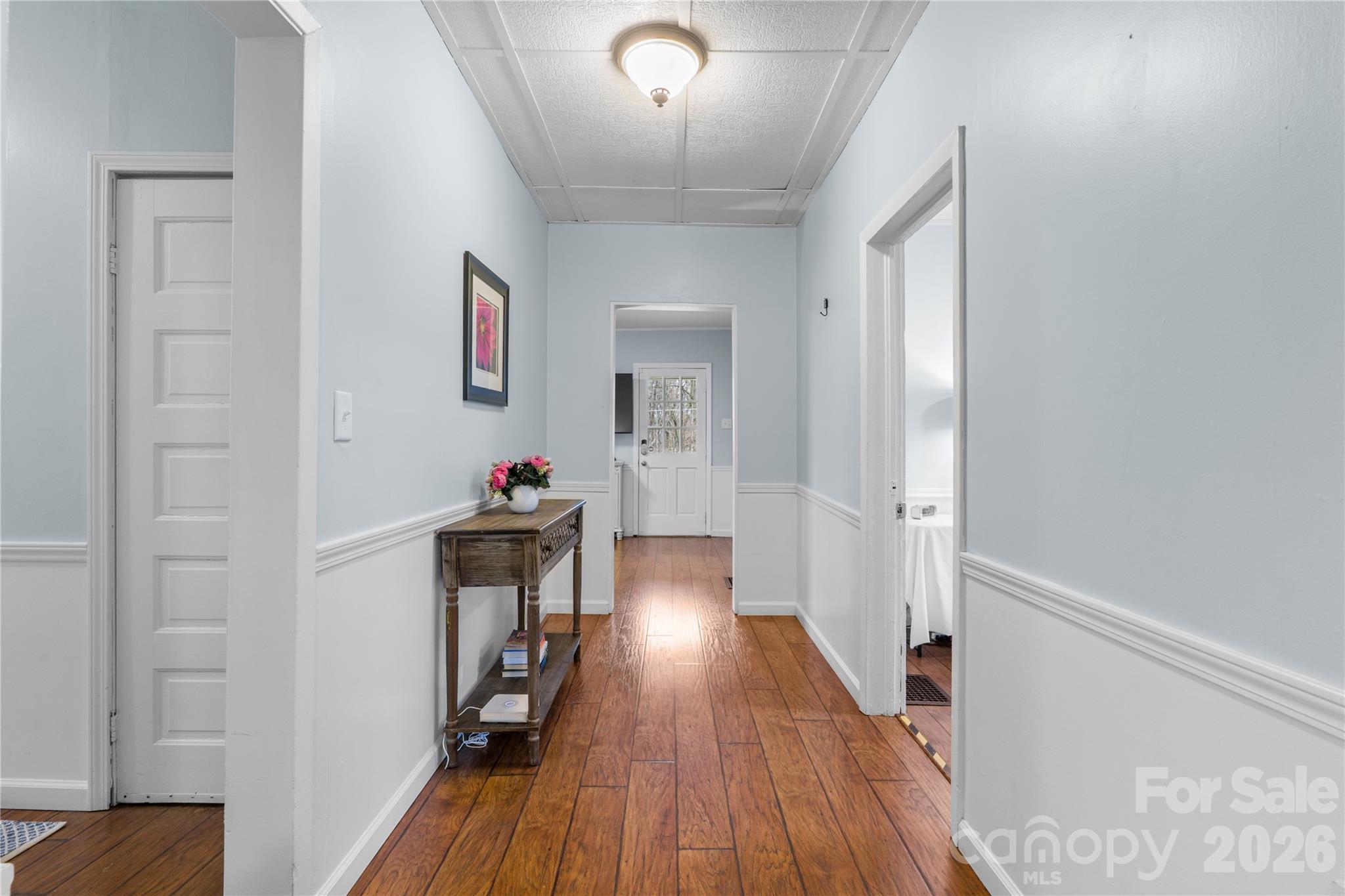 23 Maxwell Road Asheville, NC 28805 - Photo 17 of 47 a hallway with wooden floor and furniture