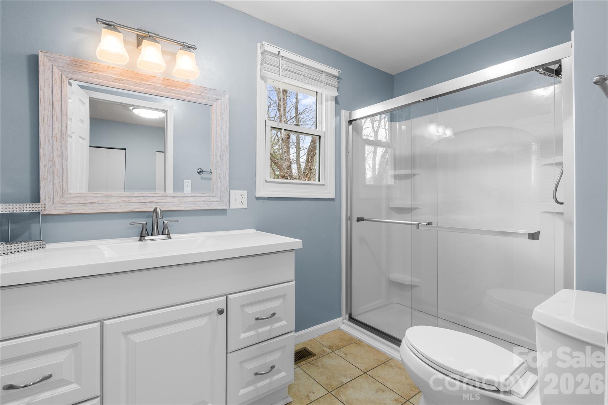 23 Maxwell Road Asheville, NC 28805 - Photo 26 of 47 a bathroom with a sink a toilet and shower