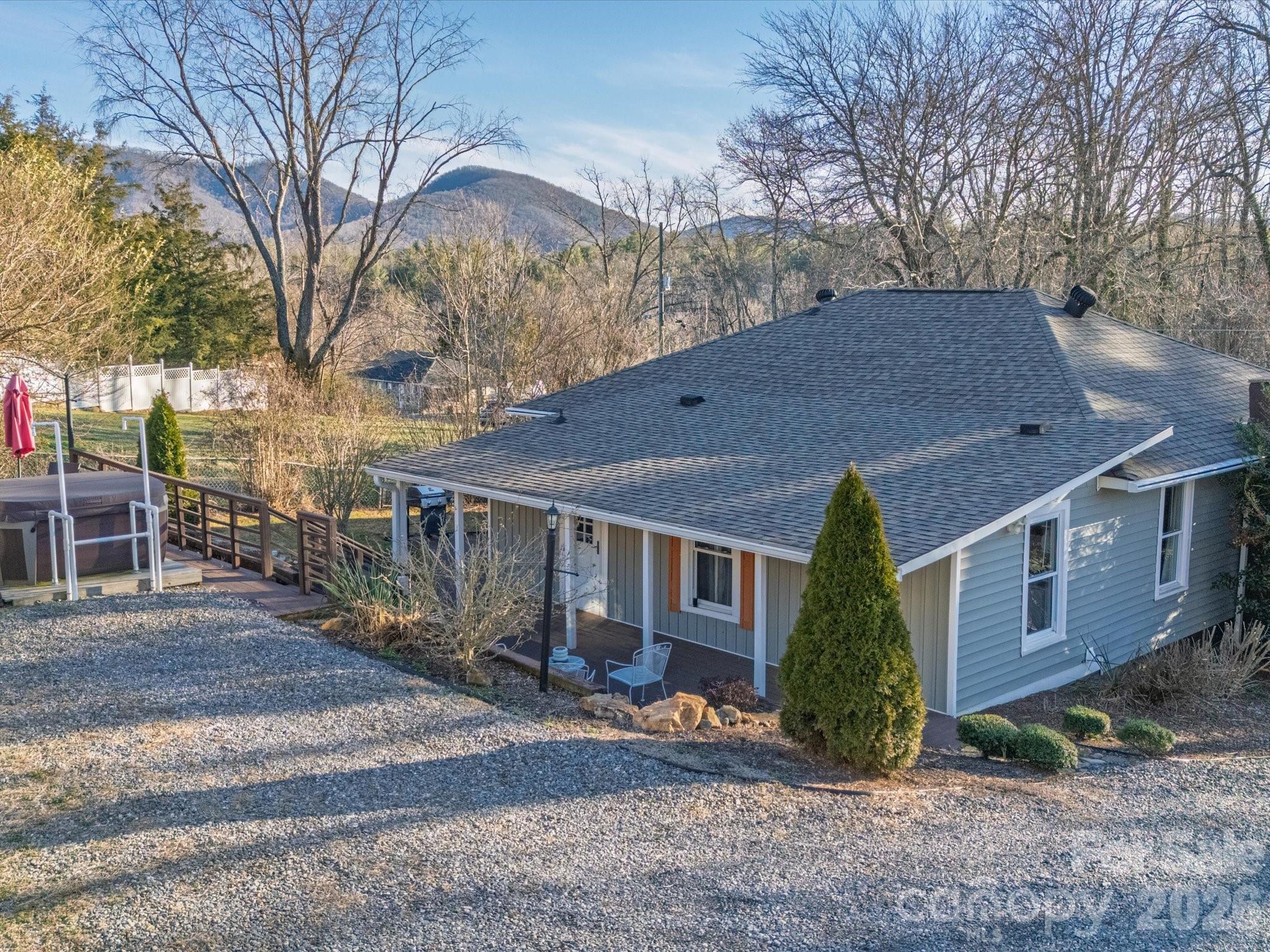 23 Maxwell Road Asheville, NC 28805 - Photo 38 of 47 a backyard of a house with barbeque oven and outdoor seating