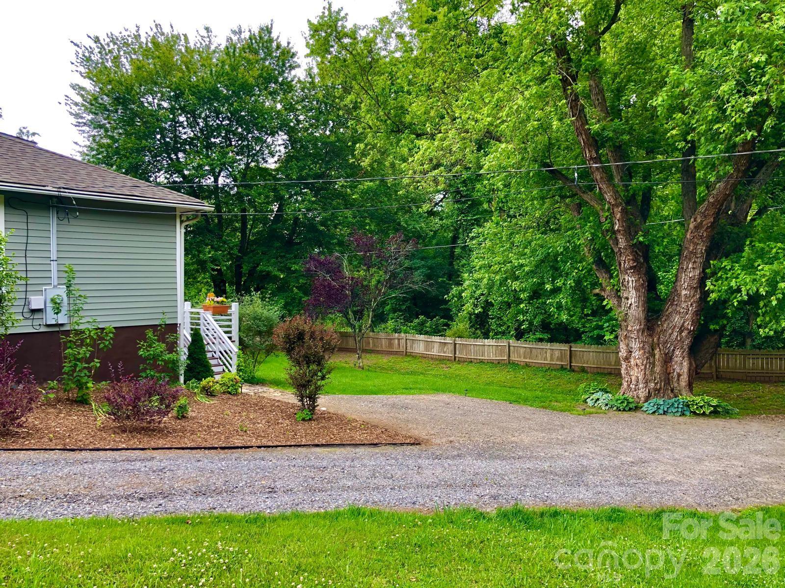 23 Maxwell Road Asheville, NC 28805 - Photo 46 of 47 a view of a house with a yard and a large tree
