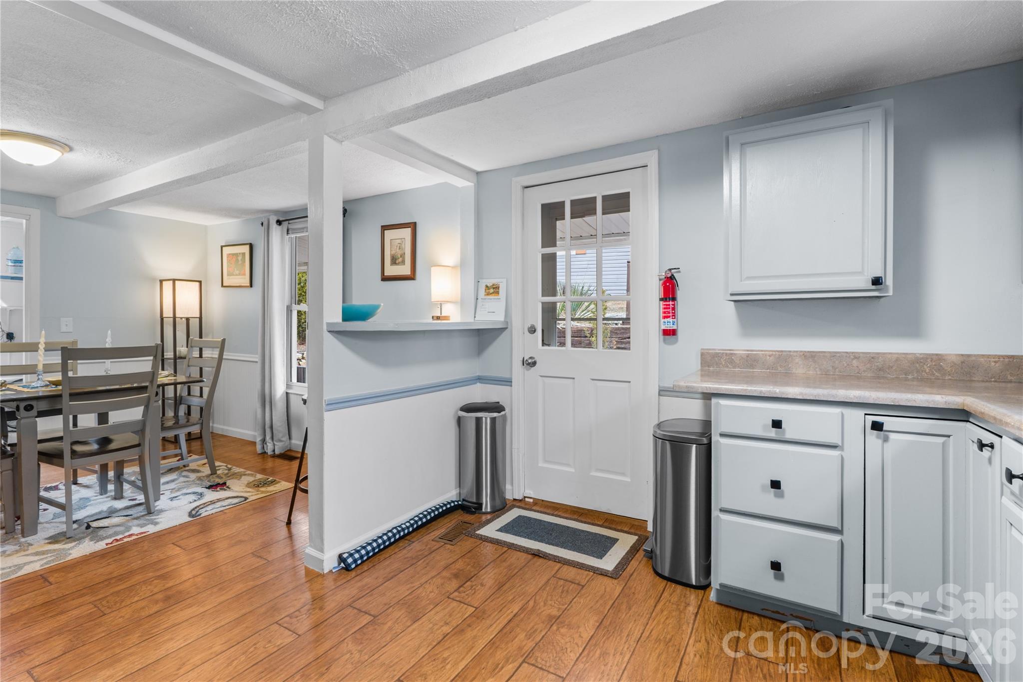 23 Maxwell Road Asheville, NC 28805 - Photo 9 of 47 a kitchen with cabinets wooden floor and a dining table
