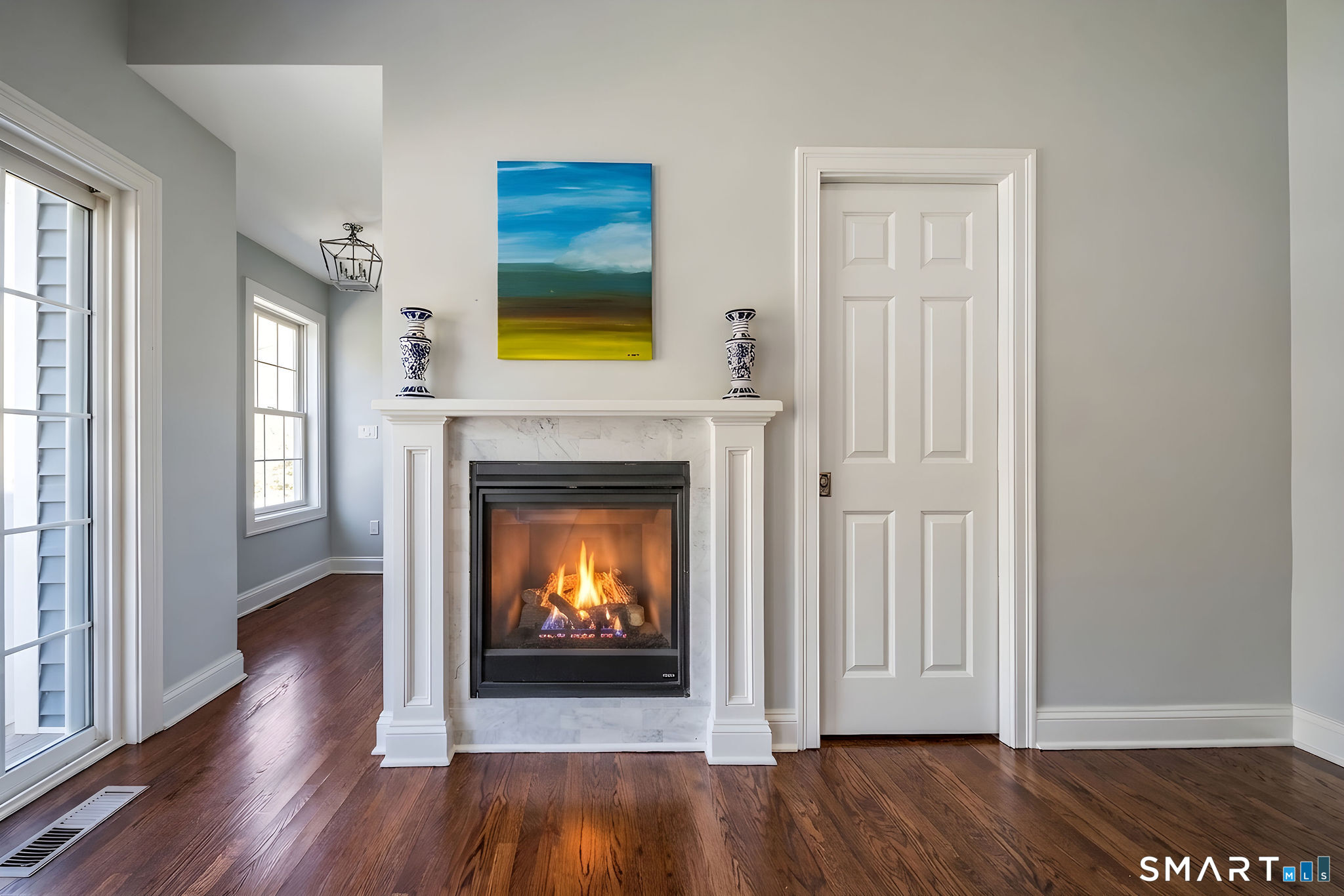 9 Sunset Ridge Drive Guilford, CT 06437 - Photo 10 of 40 a view of an empty room with wooden floor fireplace and a window