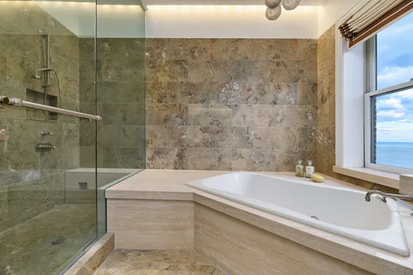 a spacious bathroom with a double vanity sink a mirror and a shower
