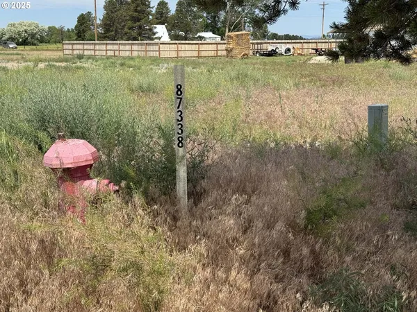 a view of a lake with a yard and trees