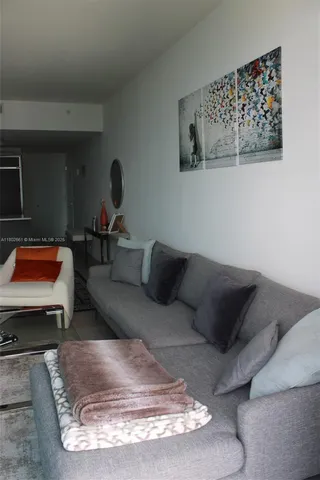 a room with furniture pool table and chairs