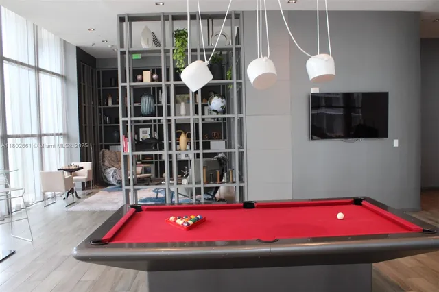 a living room with furniture wooden floor and a flat screen tv