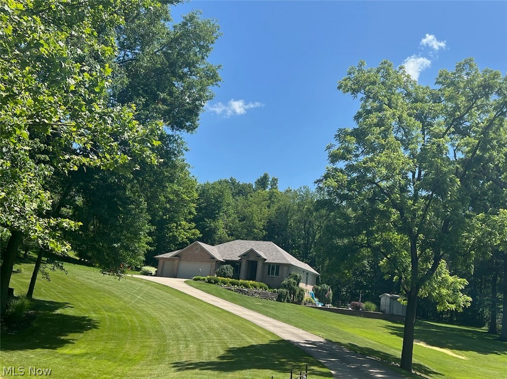 Ranch-style home with a garage and a front lawn