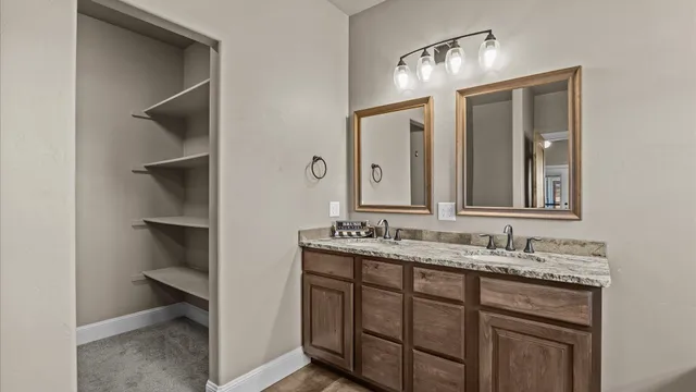 a bathroom with a double vanity sink and a mirror