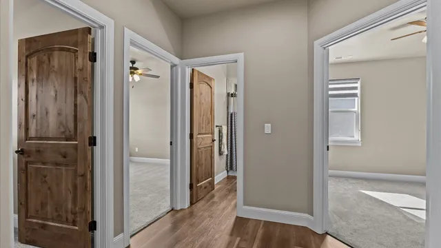 a view of a hallway with wooden floor