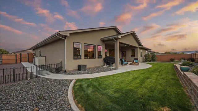a view of a house with backyard porch and sitting area