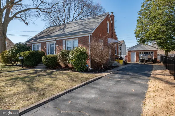 a front view of a house with a yard and a garage