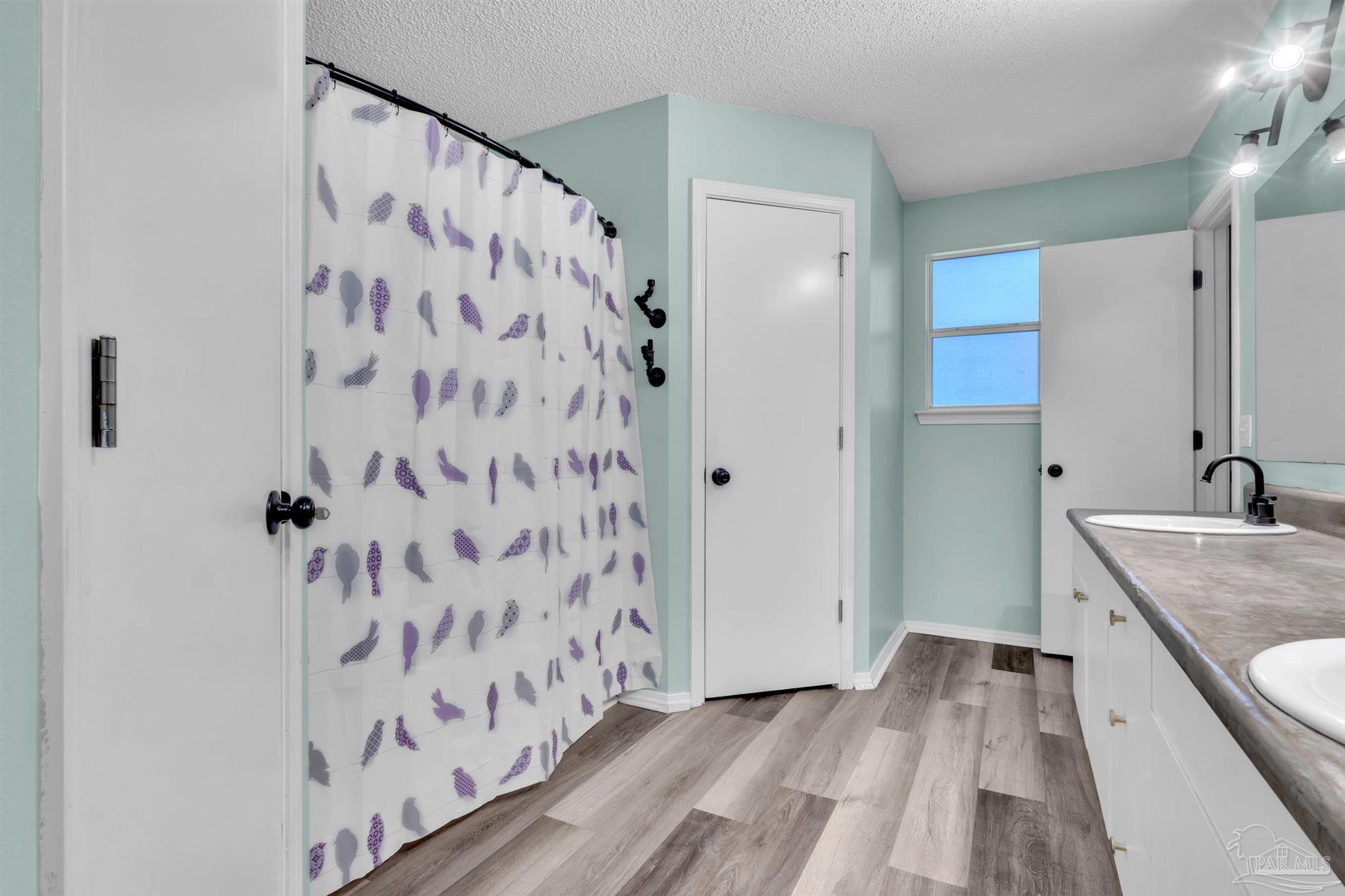 4331 Chantilly Way Milton, FL 32583 - Photo 20 of 30 a bathroom with a granite countertop shower curtain and a sink