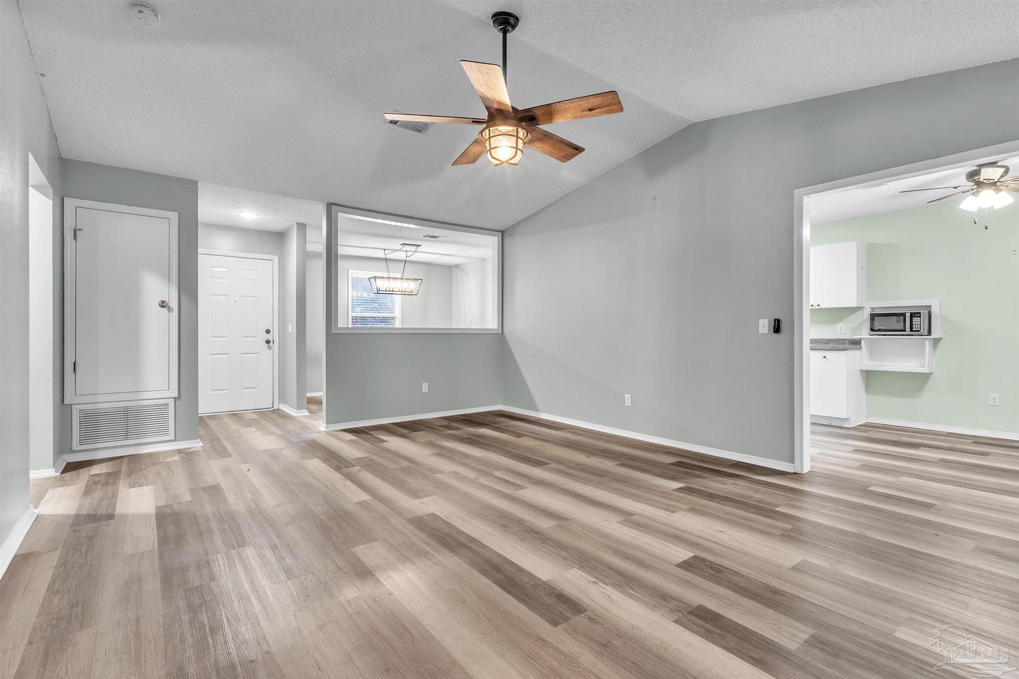4331 Chantilly Way Milton, FL 32583 - Photo 3 of 30 wooden floor in an empty room with a window