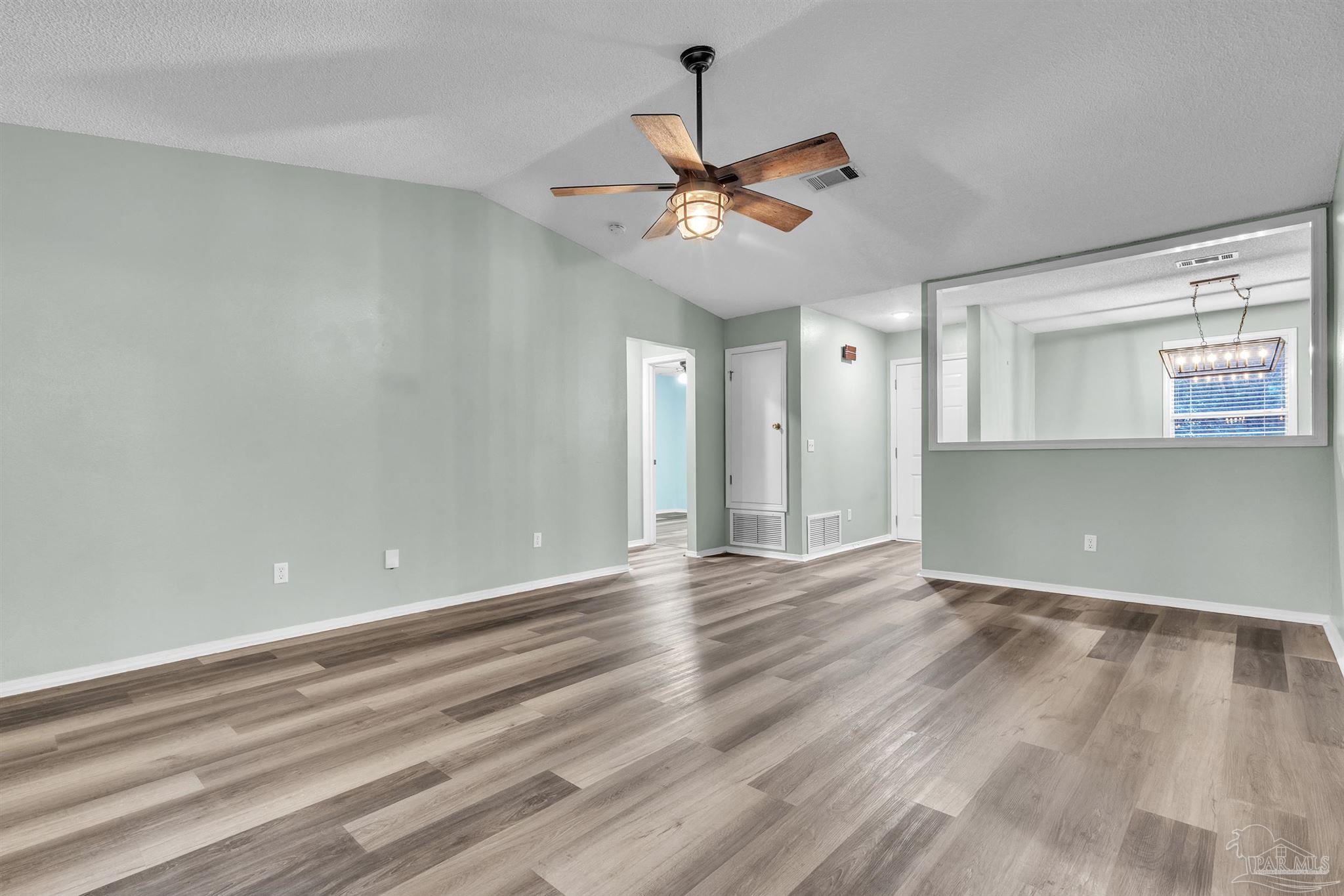 4331 Chantilly Way Milton, FL 32583 - Photo 4 of 30 wooden floor in an empty room with a window