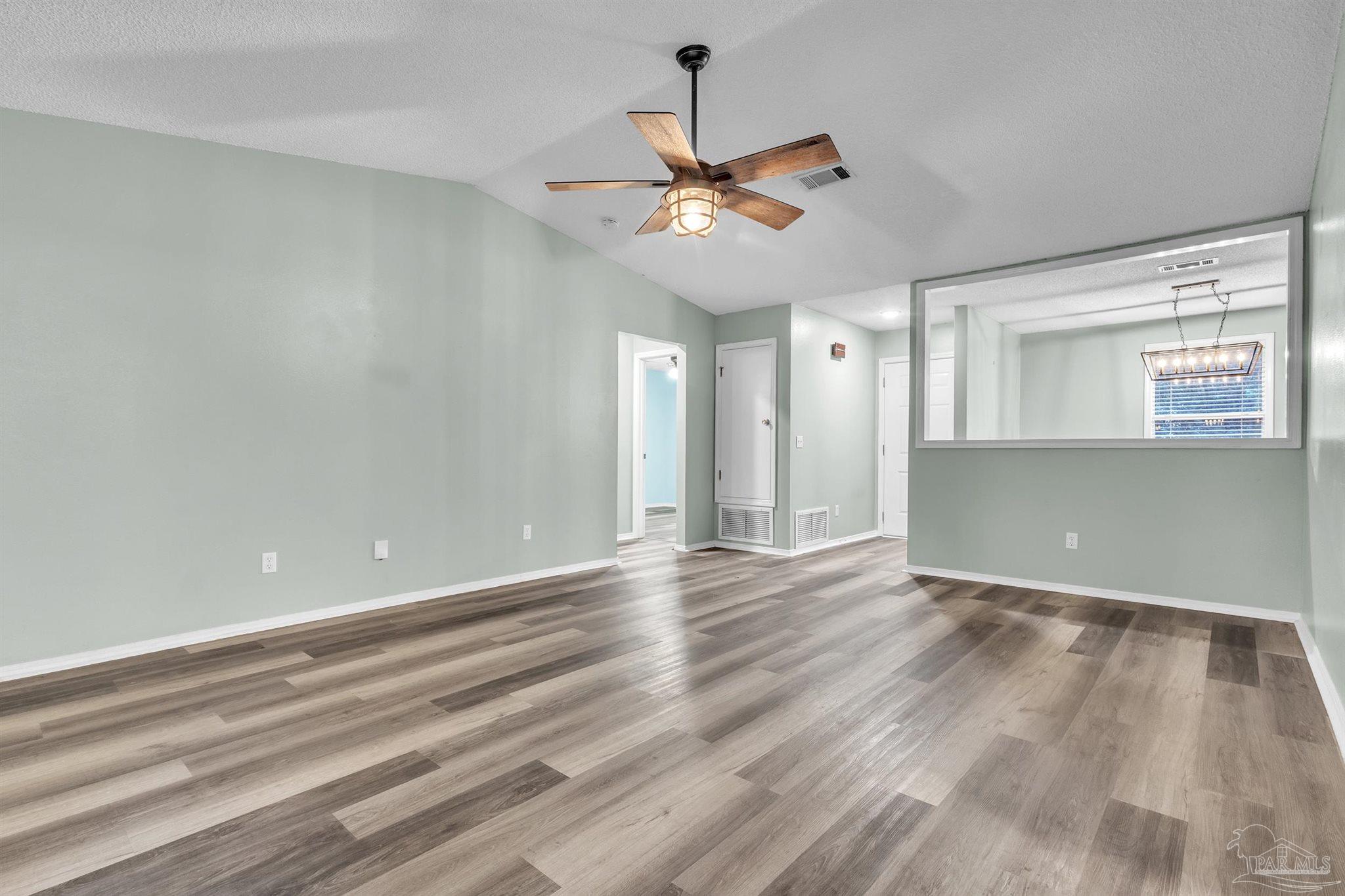 4331 Chantilly Way Milton, FL 32583 - Photo 5 of 30 wooden floor in an empty room with a window