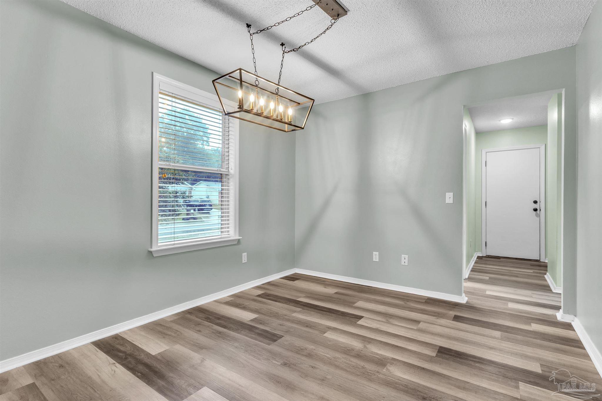 4331 Chantilly Way Milton, FL 32583 - Photo 6 of 30 a view of empty room with wooden floor and fan