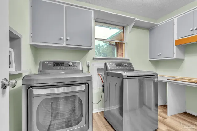 a kitchen with a stove and white cabinets
