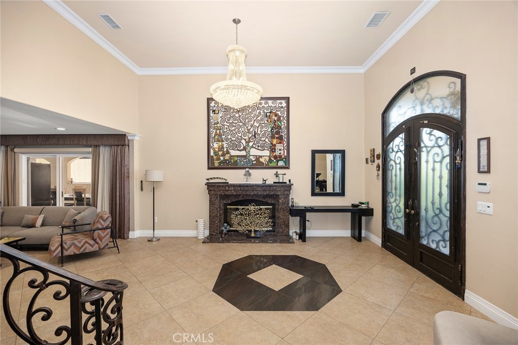 10610 Oak Tree Way Sunland, CA 91040 - Photo 13 of 63 a living room with furniture a fireplace and a chandelier