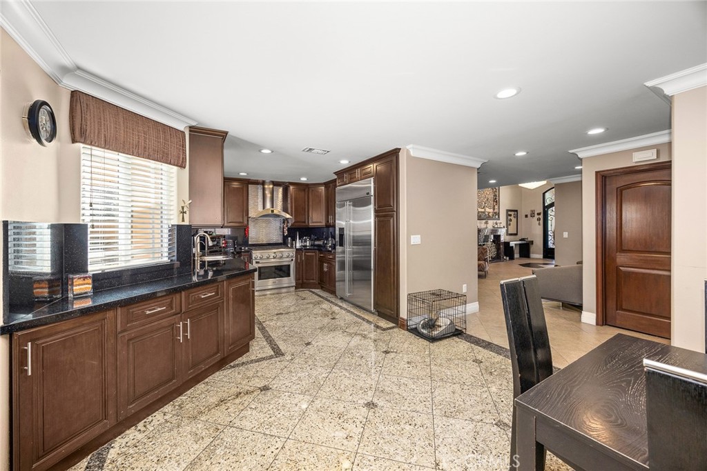 10610 Oak Tree Way Sunland, CA 91040 - Photo 22 of 63 a kitchen with stainless steel appliances kitchen island granite countertop a refrigerator a stove a sink a washer and dryer with wooden floor