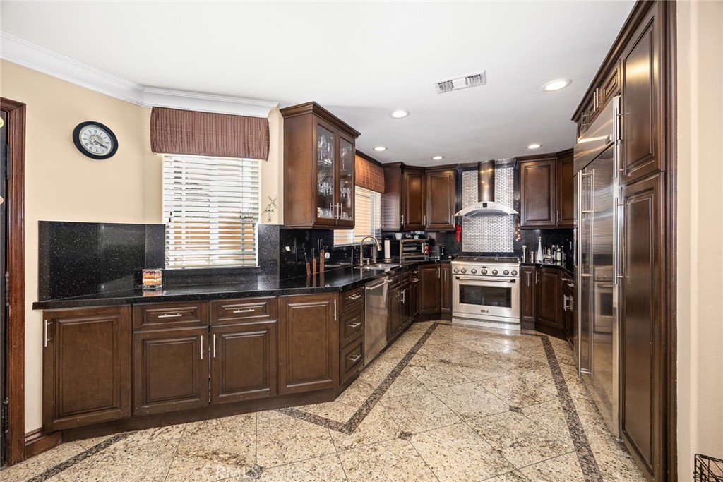 10610 Oak Tree Way Sunland, CA 91040 - Photo 23 of 63 a kitchen with stainless steel appliances granite countertop a refrigerator a stove a sink and a microwave