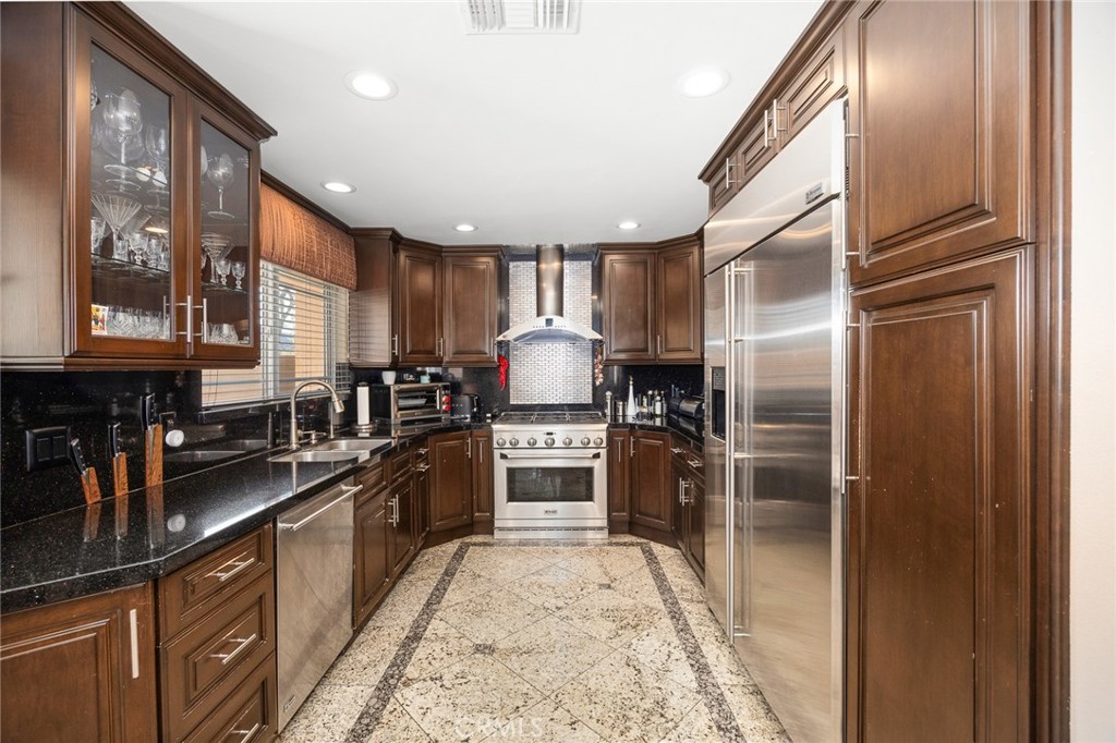 10610 Oak Tree Way Sunland, CA 91040 - Photo 24 of 63 a kitchen with stainless steel appliances granite countertop a refrigerator a stove and a sink