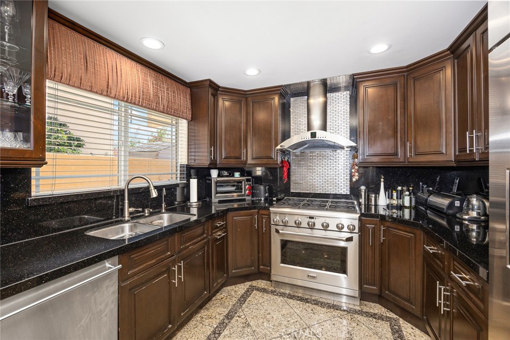 10610 Oak Tree Way Sunland, CA 91040 - Photo 25 of 63 a kitchen with granite countertop a stove sink and cabinets
