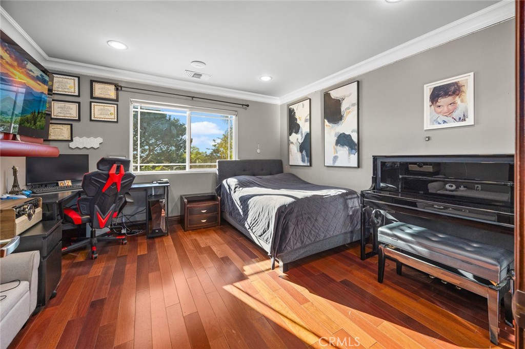 10610 Oak Tree Way Sunland, CA 91040 - Photo 28 of 63 a spacious bedroom with a bed a dresser and a large window