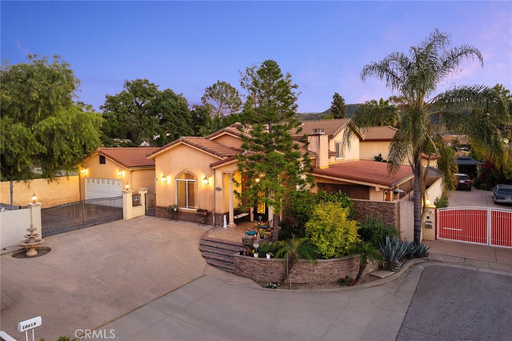 10610 Oak Tree Way Sunland, CA 91040 - Photo 3 of 63 a front view of a house with a yard and garage
