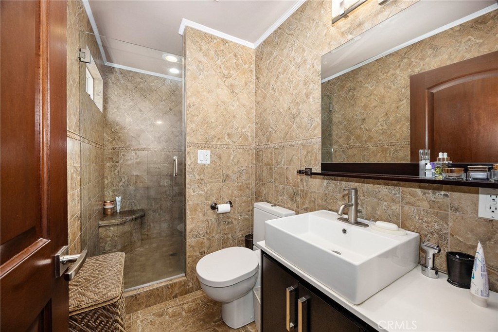 10610 Oak Tree Way Sunland, CA 91040 - Photo 31 of 63 a bathroom with a sink toilet a mirror and shower