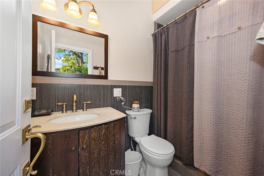 10610 Oak Tree Way Sunland, CA 91040 - Photo 40 of 63 a bathroom with a sink vanity mirror and toilet