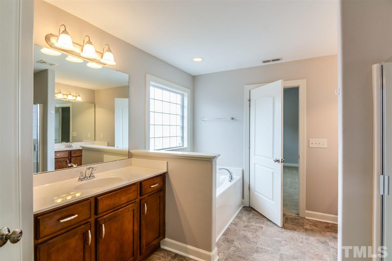 3630 Eastern Branch Road Raleigh, NC 27610 - Photo 13 of 25 a bathroom with a sink double vanity and a mirror