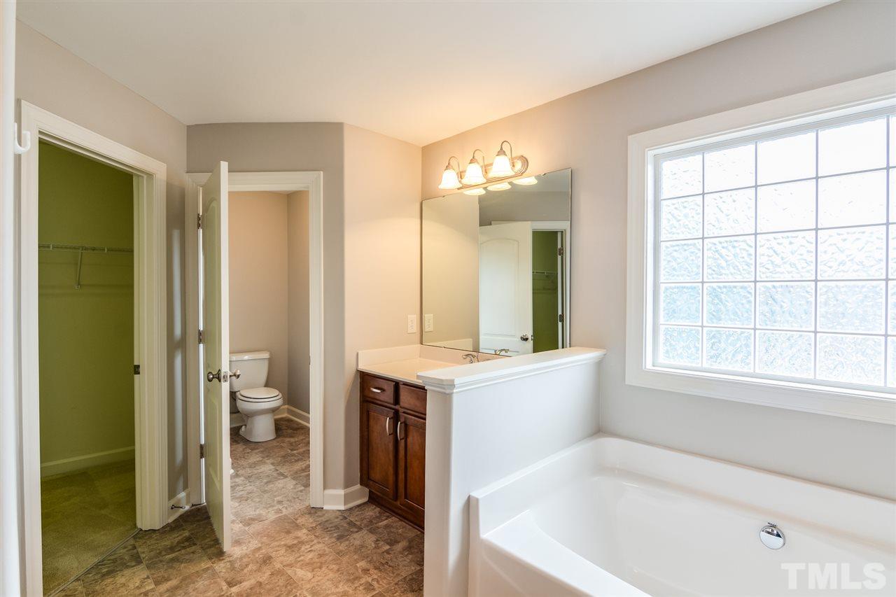 3630 Eastern Branch Road Raleigh, NC 27610 - Photo 14 of 25 a spacious bathroom with a tub sink and mirror