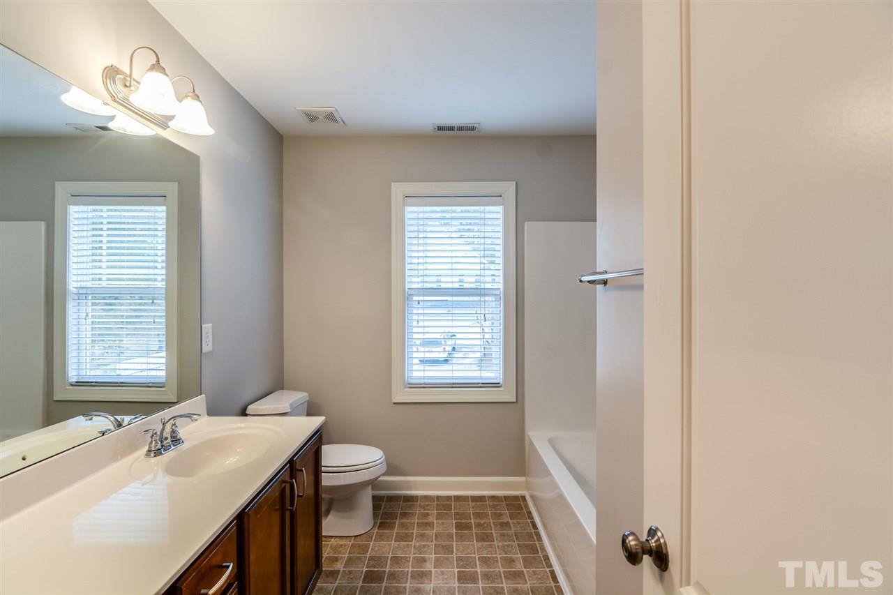 3630 Eastern Branch Road Raleigh, NC 27610 - Photo 20 of 25 a bathroom with a sink a toilet and window