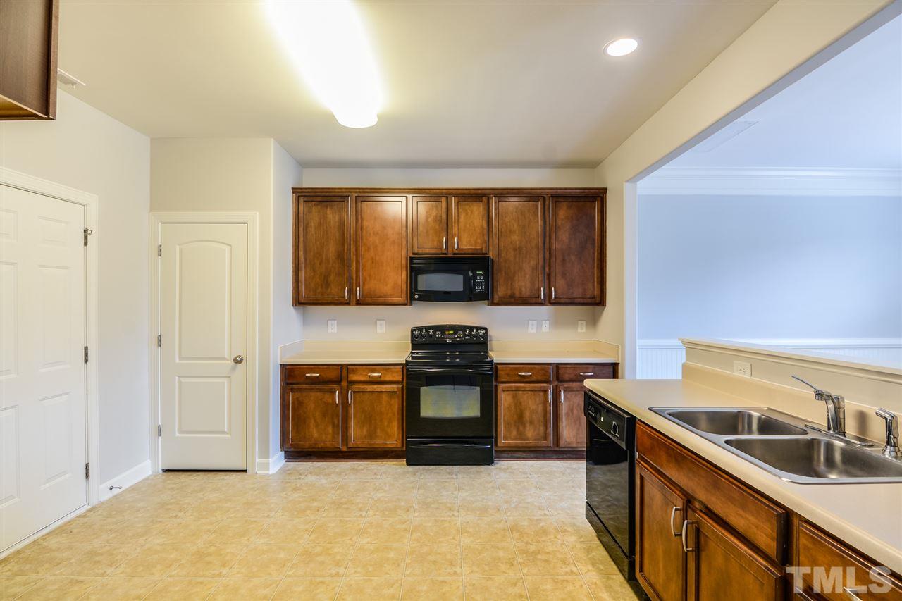 3630 Eastern Branch Road Raleigh, NC 27610 - Photo 7 of 25 a kitchen with stainless steel appliances granite countertop a stove and a sink