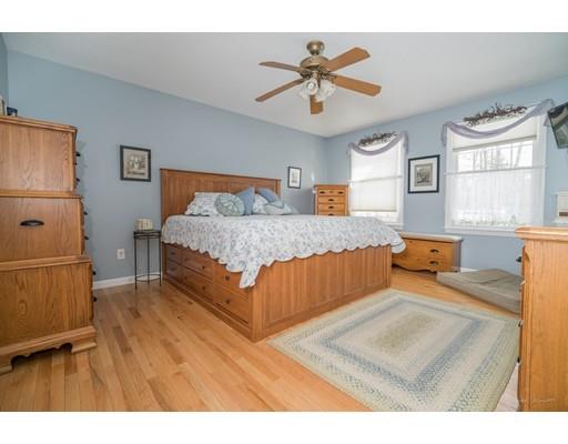 44 Old Reed Road Monson, MA 01057 - Photo 16 of 30 a bedroom with a bed and a chandelier