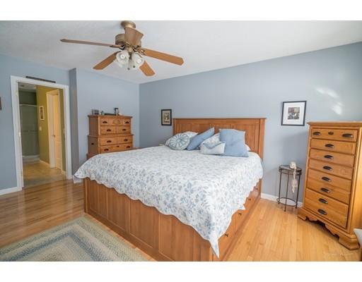 44 Old Reed Road Monson, MA 01057 - Photo 18 of 30 a bedroom with a bed and a chandelier