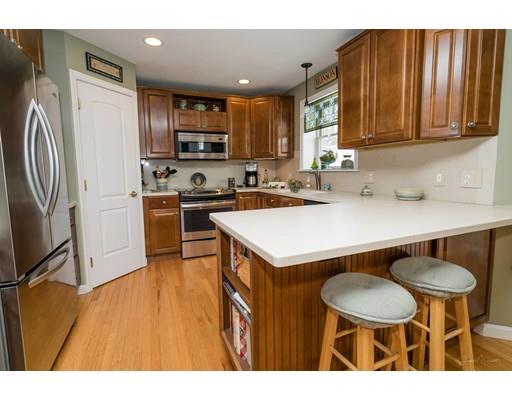 44 Old Reed Road Monson, MA 01057 - Photo 9 of 30 a kitchen with stainless steel appliances a table chairs microwave and refrigerator