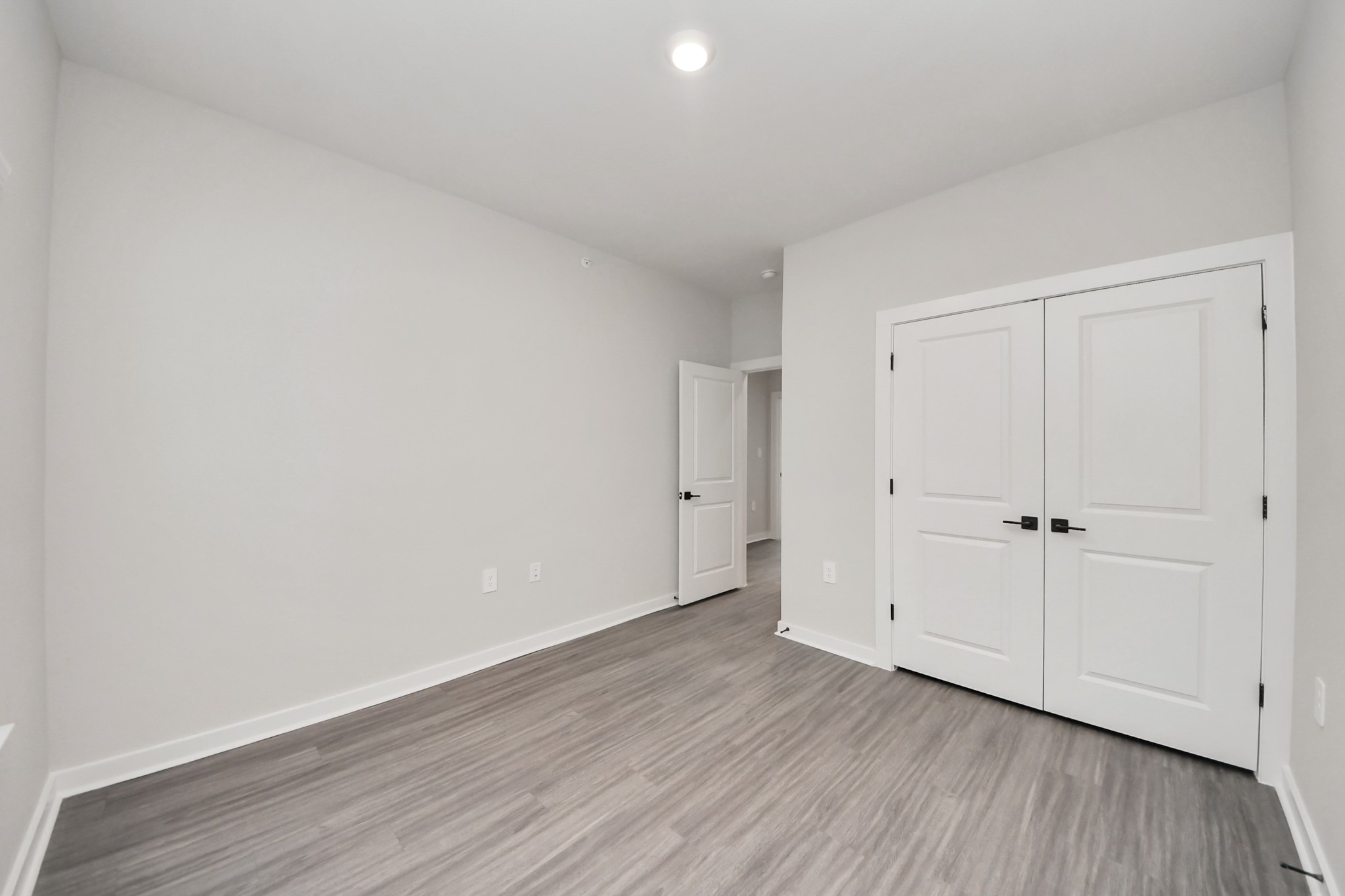 7711 Longmire Road, Unit 102 Conroe, TX 77304 - Photo 10 of 48 a view of an empty room and wooden floor
