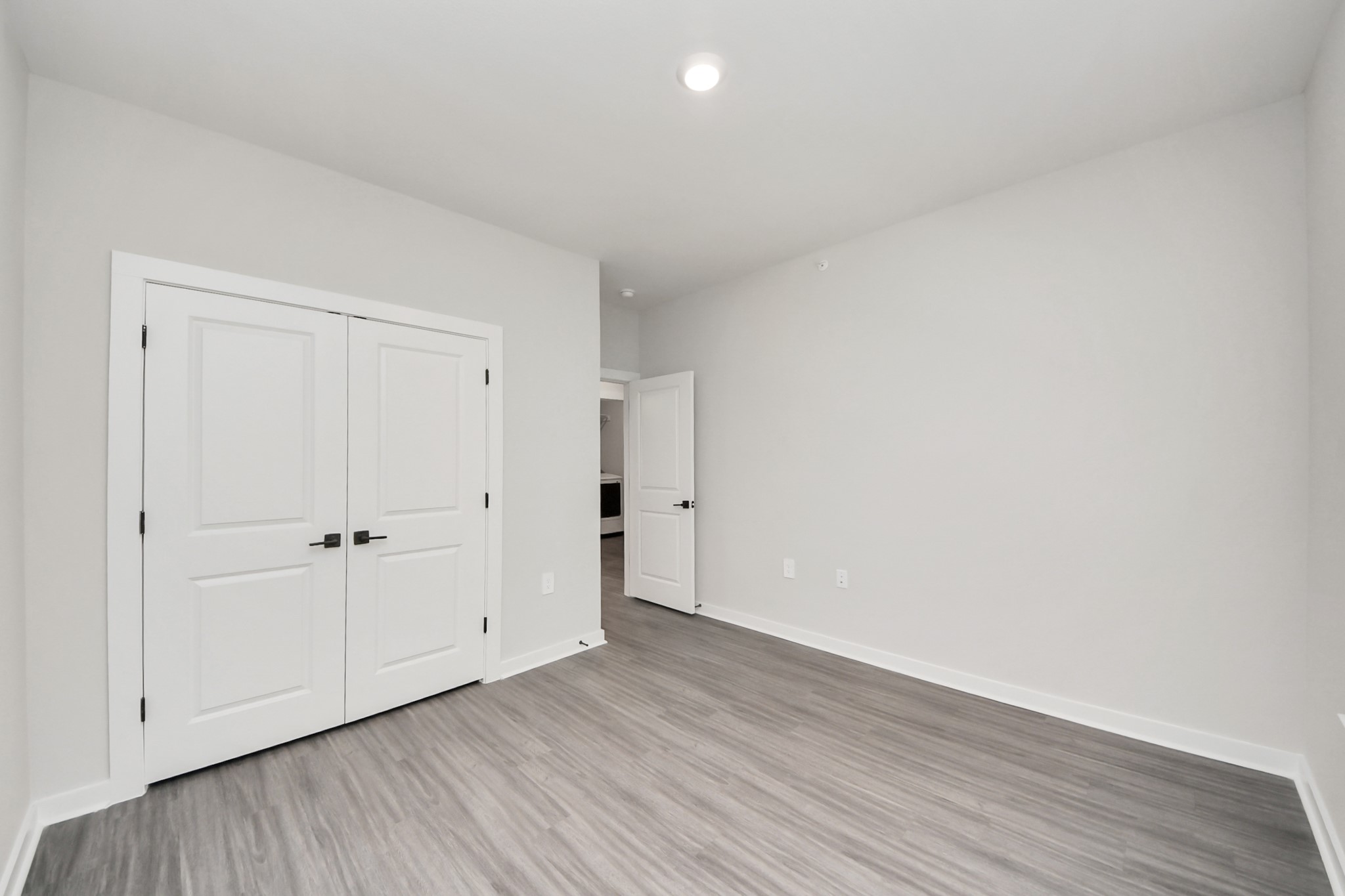 7711 Longmire Road, Unit 102 Conroe, TX 77304 - Photo 14 of 48 a view of an empty room with wooden floor