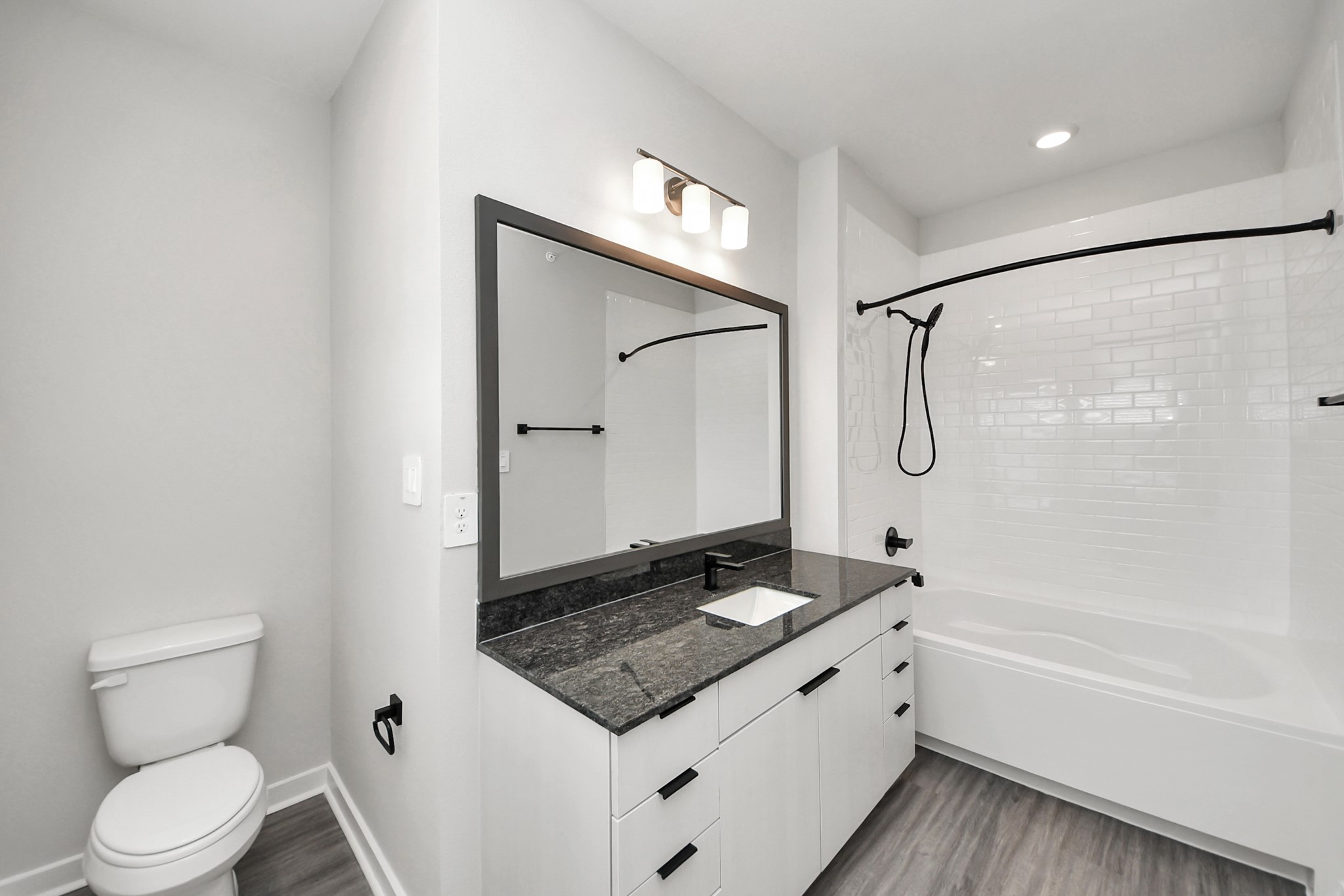 7711 Longmire Road, Unit 102 Conroe, TX 77304 - Photo 19 of 48 a bathroom with a granite countertop sink toilet and shower