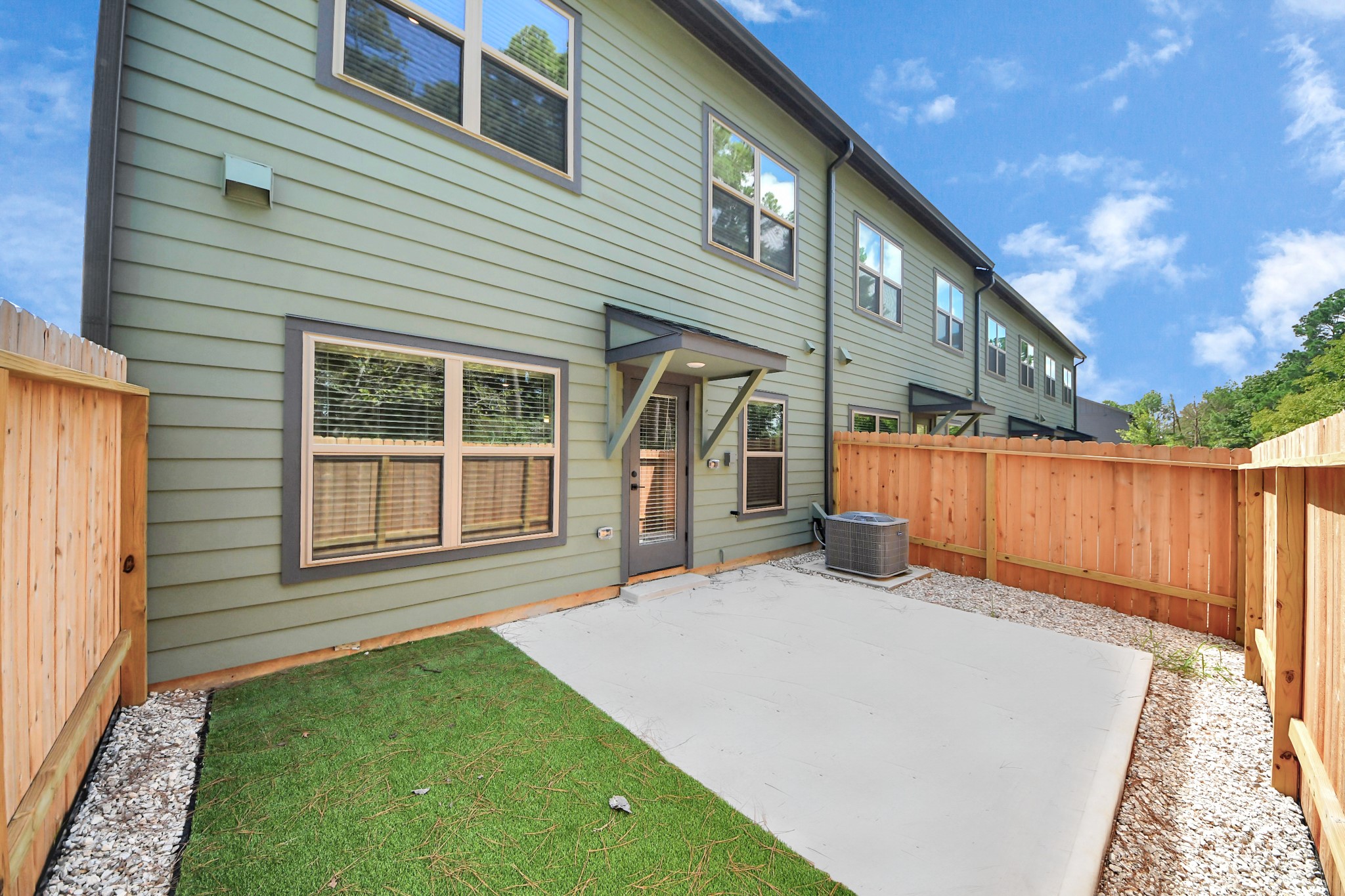 7711 Longmire Road, Unit 102 Conroe, TX 77304 - Photo 2 of 48 a view of a house with a backyard