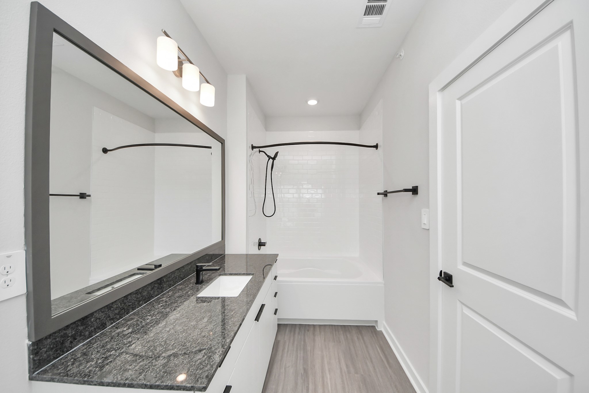 7711 Longmire Road, Unit 102 Conroe, TX 77304 - Photo 21 of 48 a bathroom with a tub shower vanity and a sink