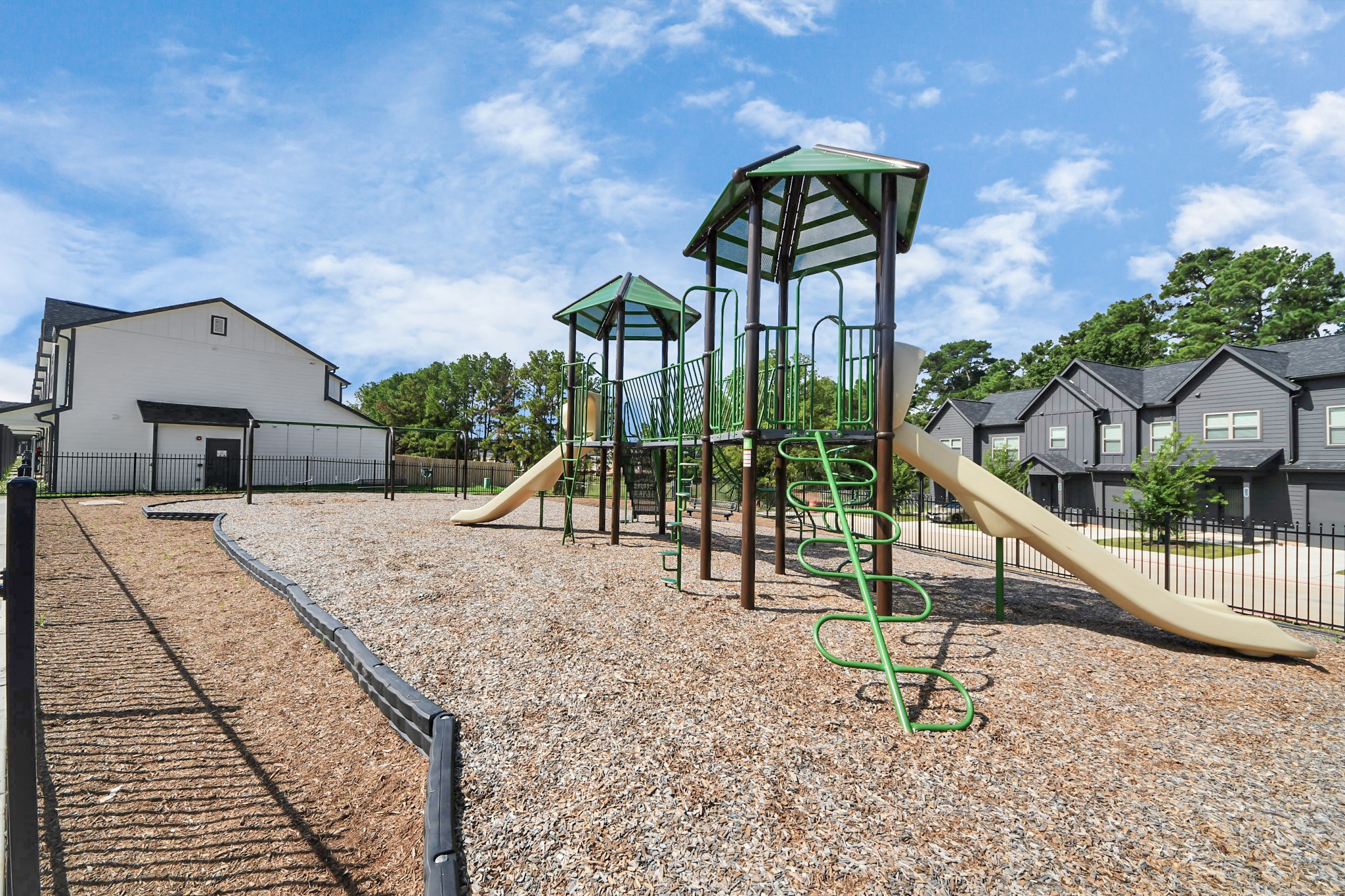 7711 Longmire Road, Unit 102 Conroe, TX 77304 - Photo 23 of 48 a view of a house with backyard and a slide
