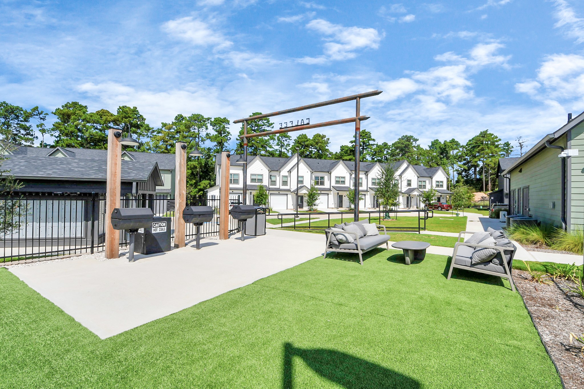 7711 Longmire Road, Unit 102 Conroe, TX 77304 - Photo 25 of 48 a view of a house with backyard porch and sitting area