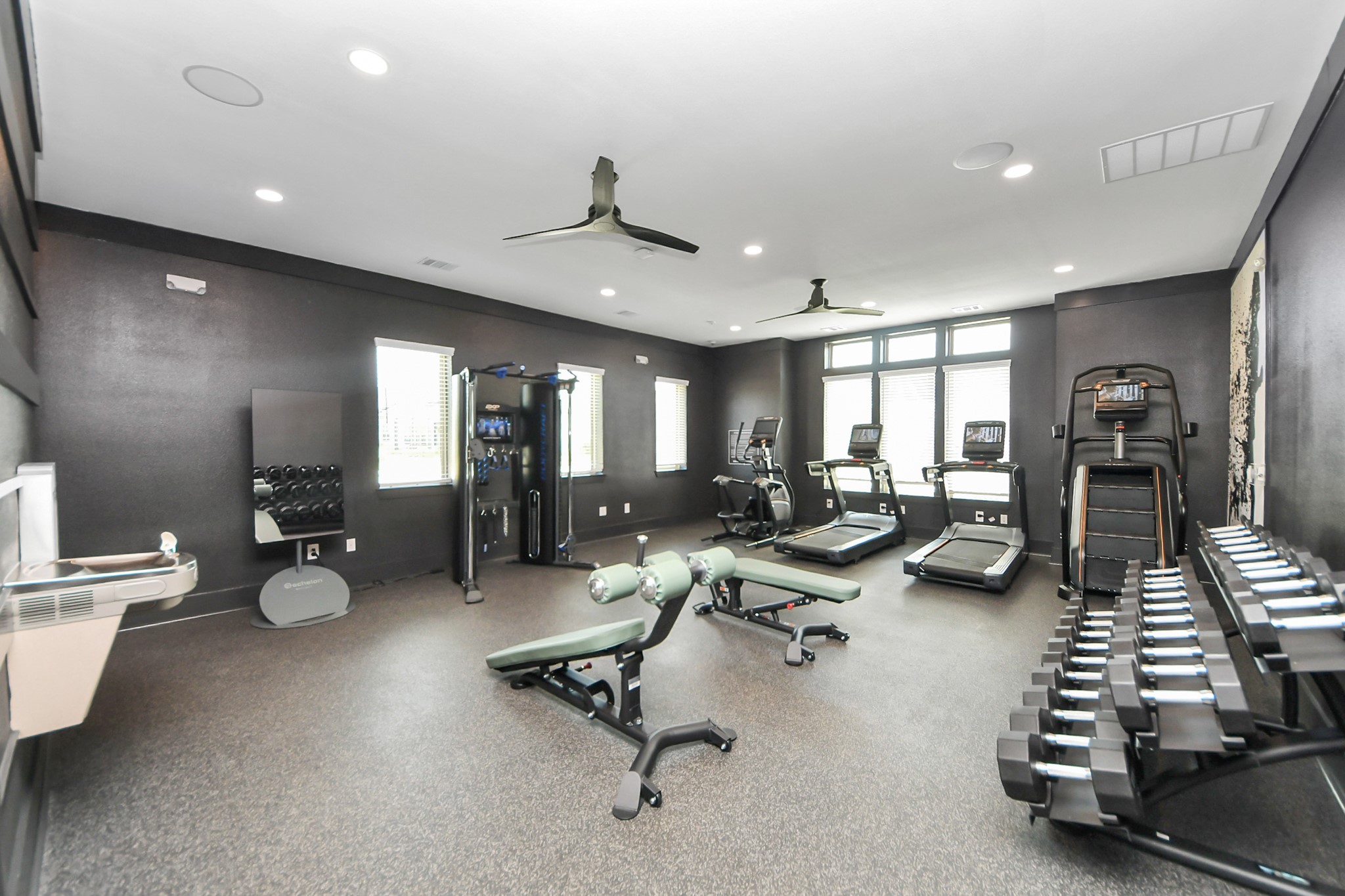 7711 Longmire Road, Unit 102 Conroe, TX 77304 - Photo 31 of 48 a room with gym equipment and a large window