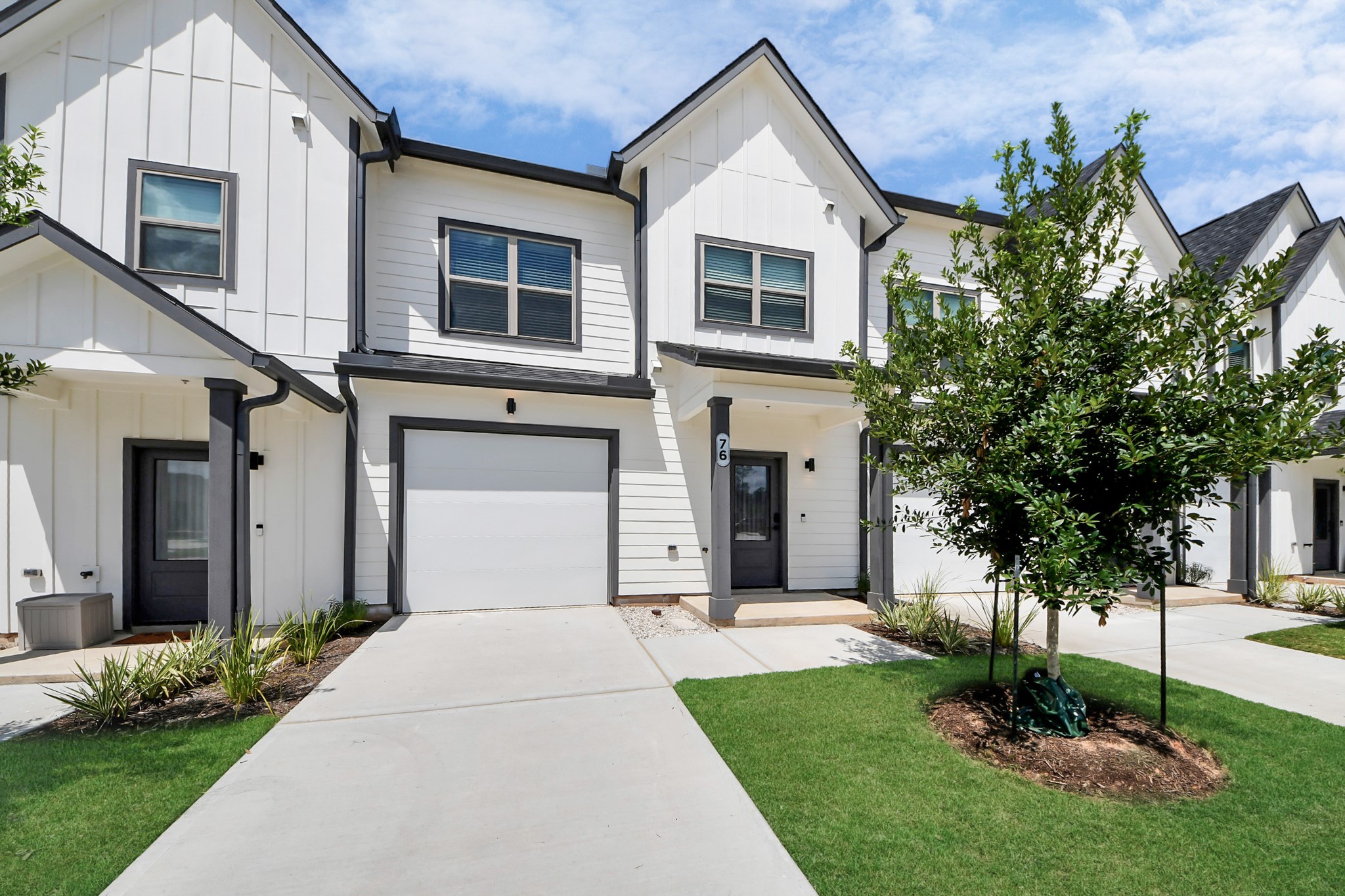 7711 Longmire Road, Unit 102 Conroe, TX 77304 - Photo 37 of 48 a front view of a house with garden
